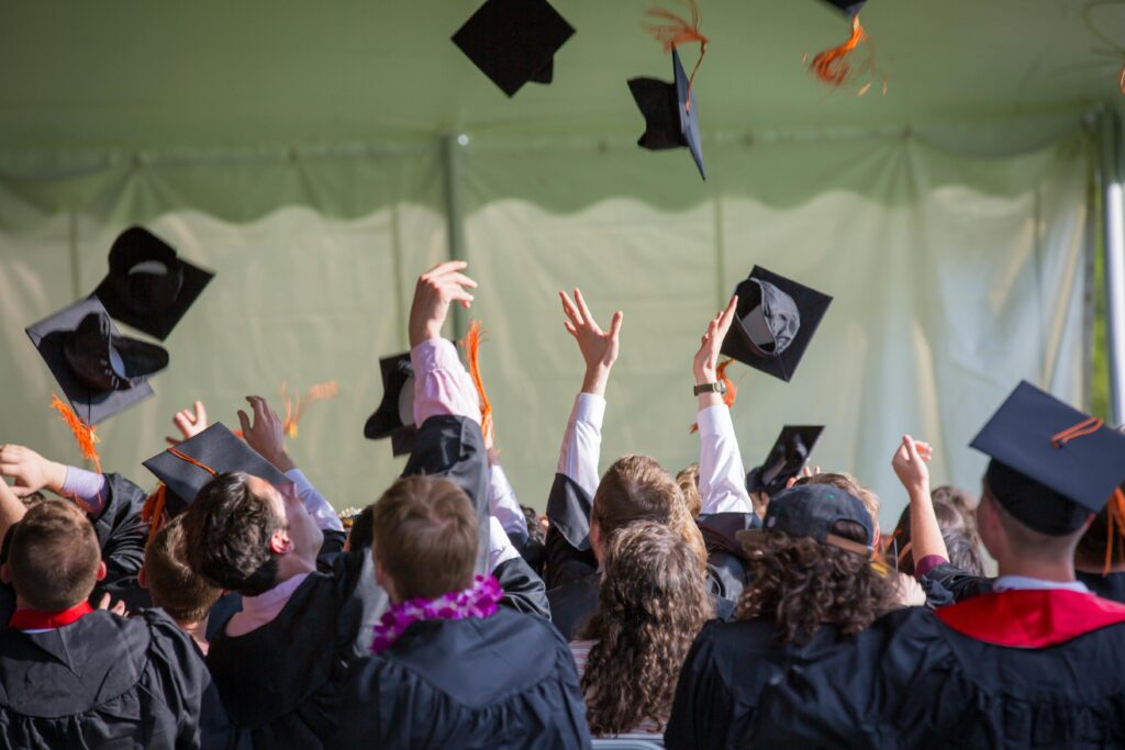 pexels photo 1205651 1205651 Group of graduates celebrating by tossing caps into the air during a graduation ceremony.