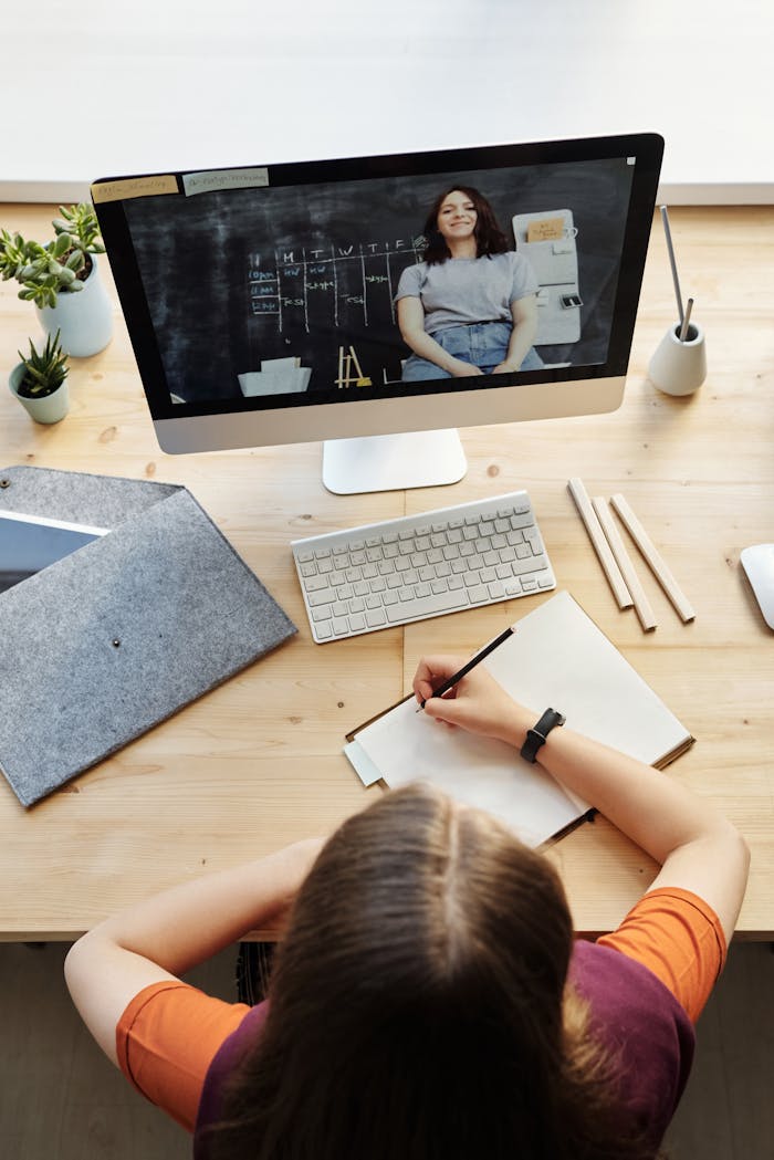 Mastering the First Impression: Your intriguing post title goes here A teenage student attentively participates in a virtual classroom setting from a home office workspace.